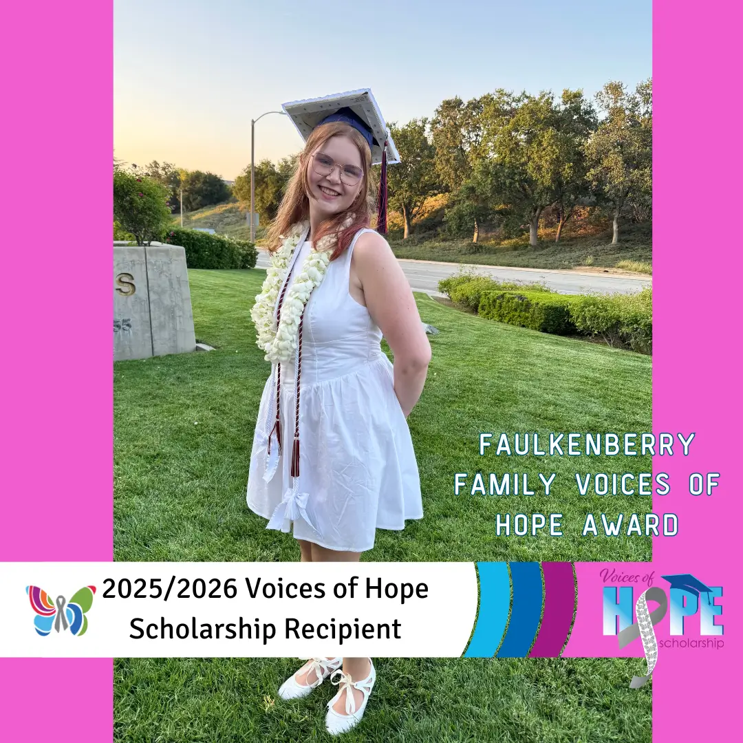 A smiling graduate in cap and gown holding a diploma outdoors.