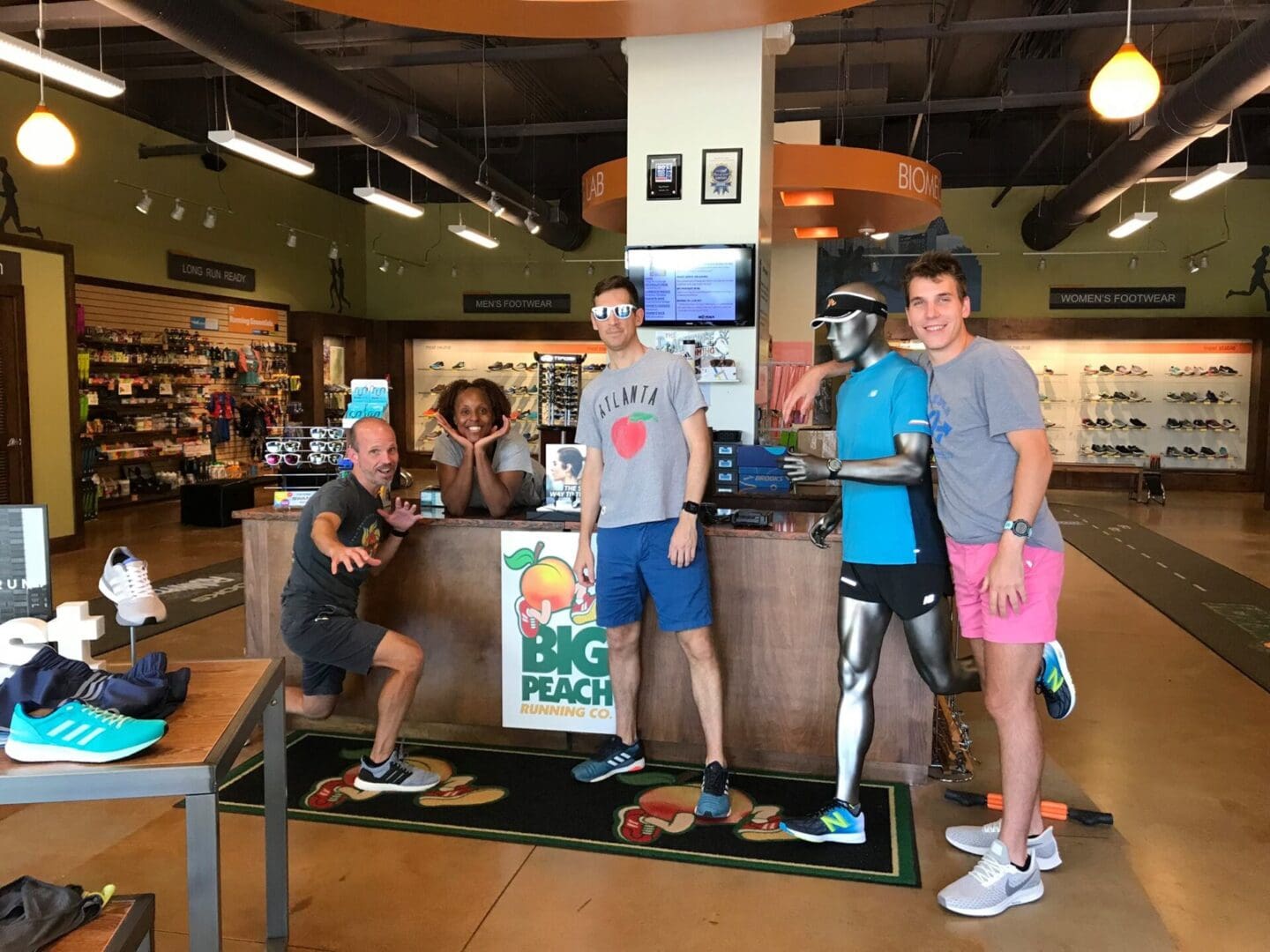 People standing at the store of big peachan making poses