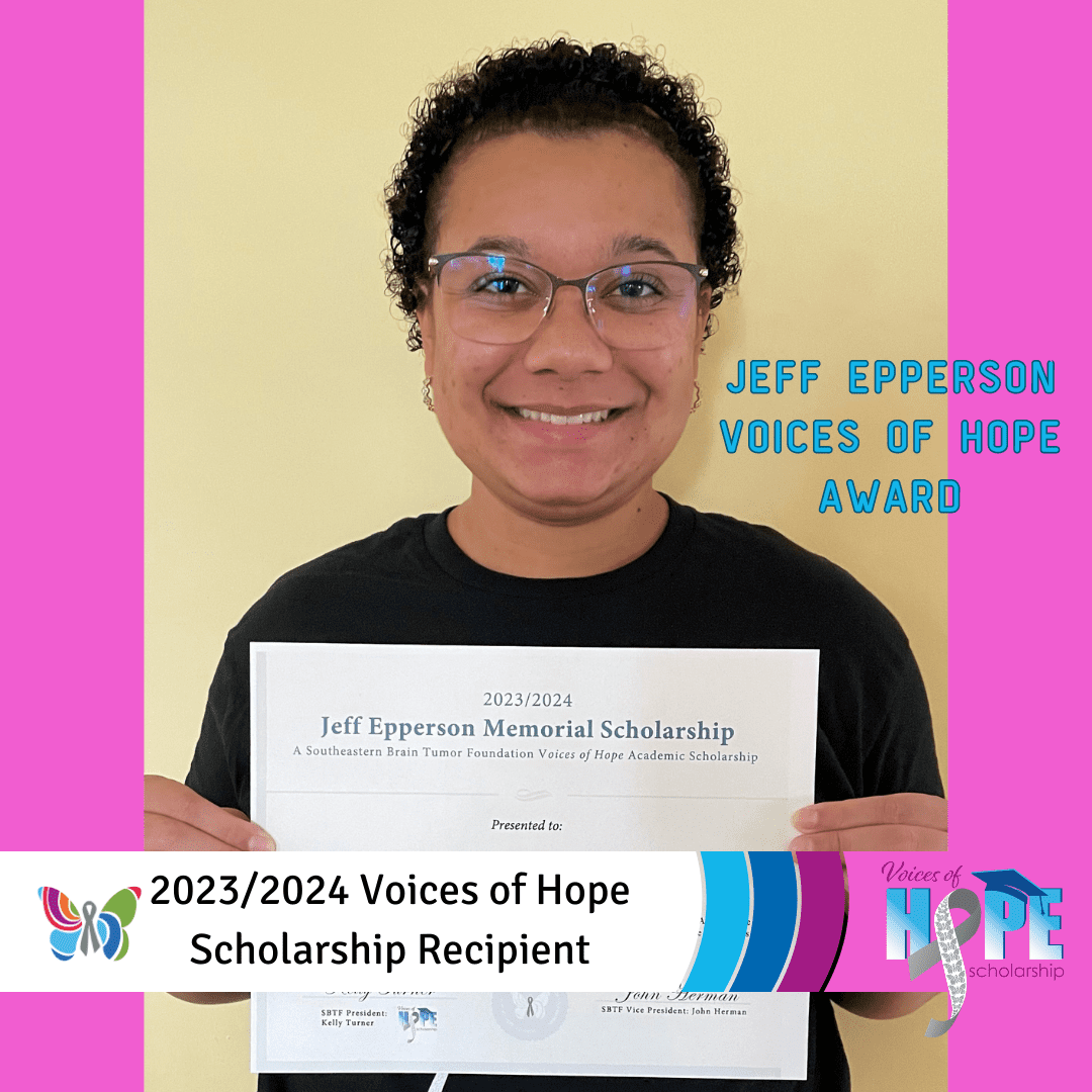 A person standing holding a paper written jeff epperson memorial scholarship