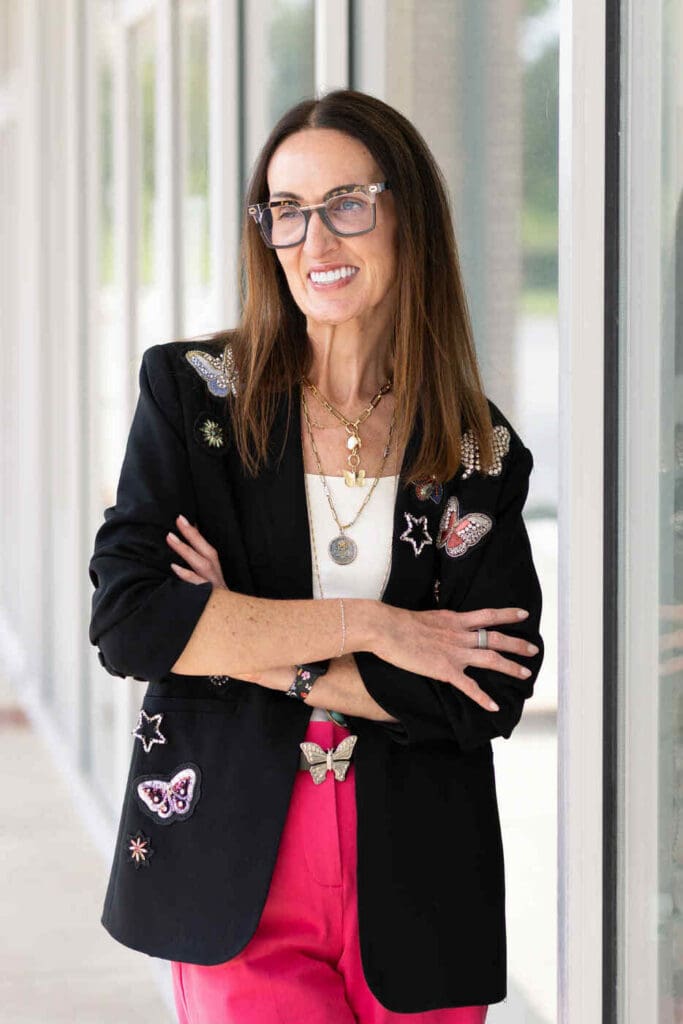 CiCi Hope smiling, wearing a black blazer decorated with beaded butterflies